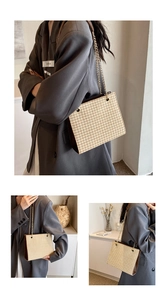 Detail of woven texture and brown leather side panel on a stylish shoulder tote bag