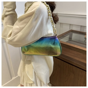 Detail of holographic faux leather shoulder bag with glossy metallic texture and gold chain