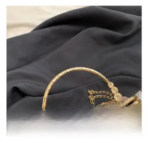 Detail of vintage floral evening bag with golden round handle and metallic bead clasp