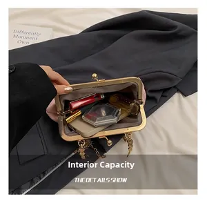 Internal capacity of pink velvet embroidery bag showing phone and cosmetics