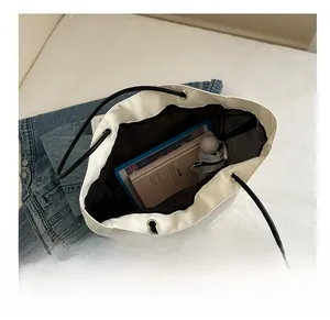 Interior view of white tote bag showing storage capacity for tablet and umbrella