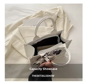 Detailed interior view of a white tote bag showing spacious capacity and central zipper