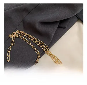 Close-up of polished gold metal chain strap on vintage Chinese embroidery handbag