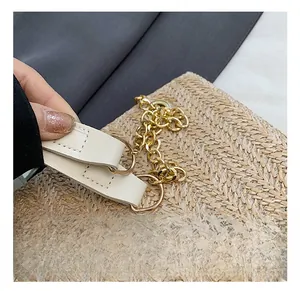 Detail shot of beige woven bag featuring premium gold chain and faux leather straps