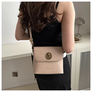Détail du sac bandoulière abricot avec fermoir métallique vintage et logo de marque