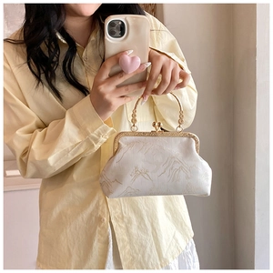 Detailed embroidery of golden landscape on ivory silk cheongsam handbag with metal handle