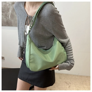 Close-up of mint green Oxford cloth shoulder bag showing texture and stitching details