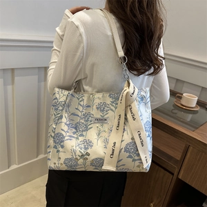 Floral print shoulder bag with blue hydrangea patterns and elegant ribbon detail