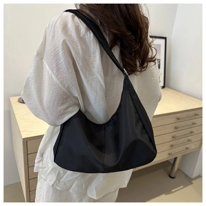 Minimalist black oxford fabric crescent bag with adjustable wide shoulder strap detail