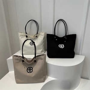 Minimalist canvas tote bags in white black and khaki colors with circular logo print