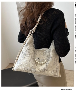 Detail of white butterfly tote bag featuring plush texture and elegant pearl metal chain