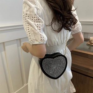 Elegant heart-shaped crossbody bag with silver studs and gold chain strap
