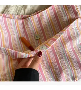Detail of the durable striped canvas bag interior featuring a magnetic snap closure and pocket