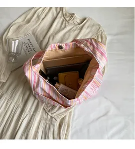 Internal view of spacious canvas tote bag showing storage capacity and metal snap button