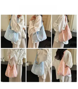 Detail view of large capacity nylon tote with pink and blue stripe patterns and external pocket