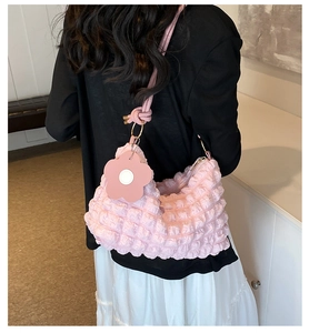 Pink bubble texture shoulder bag with flower charm detail and leather strap