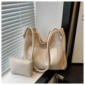 Detailed set of woven tote bag and leather clutch in cream white with shadow lighting