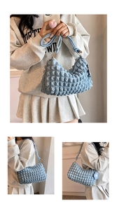 Detail of light blue popcorn texture shoulder bag with golden rings and floral charm