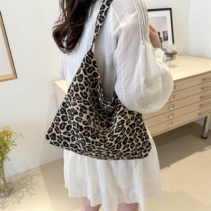 Stylish leopard print canvas tote bag with large capacity shown in a back view on a model
