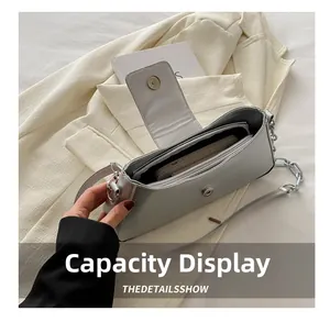 Detail shot of the silver baguette bag interior showing capacity for phone and wallet