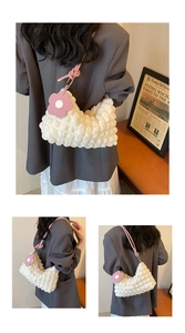 Detail of white bubble texture tote bag with pink straps and flower charm detail