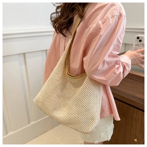 Detailed close-up of woven mesh texture and khaki leather trim on the beige shoulder hobo bag