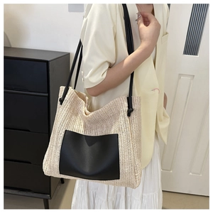 Straw tote bag with black leather pocket and shoulder straps, casual summer style