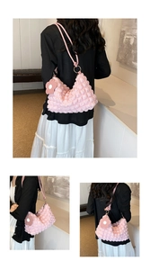 Pink bubble pleated shoulder bag detail featuring 3D texture and flower charm