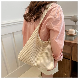 Detailed texture of hand-woven beige tote bag styled with casual summer outfit