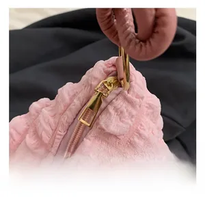 Detail view of pink bubble textured tote bag featuring gold hardware and metal zipper