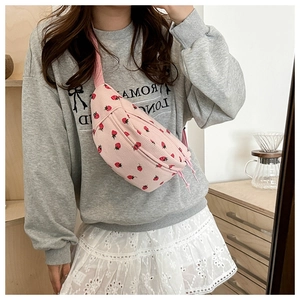 Detailed texture of pink corduroy strawberry print waist bag with dual zippers