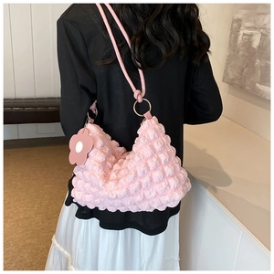 Detailed back view of pink pleated bubble shoulder bag with floral charm and gold rings