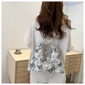 White butterfly print tote bag with metal chain strap and pearl butterfly charm