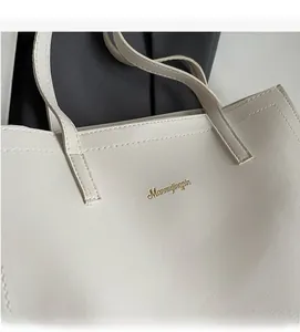 Close-up of cream white tote bag featuring premium lychee texture and fine stitching detail