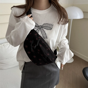 Black corduroy shoulder bag with red strawberry pattern and adjustable strap for women