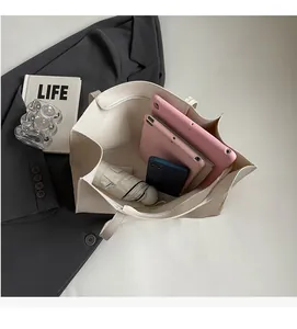 Top view of large capacity cream tote bag showing internal storage for tablets and umbrella