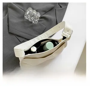 Top-down view of cream leather saddle bag showing spacious interior for essentials