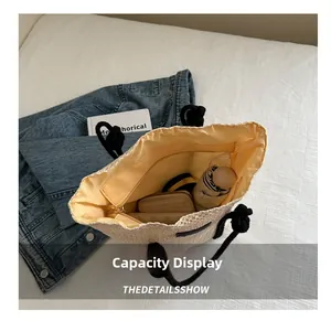 Top view of woven straw tote bag showing spacious interior with fabric lining and pocket