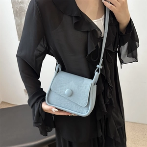 Chic light blue lychee pattern saddle bag with round buckle for elegant women