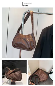 Brown PU leather underarm bag featuring adjustable strap and minimalist front seam detail