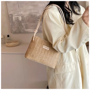 Detail of vintage straw bucket bag featuring fine wave-weave texture and fashion label