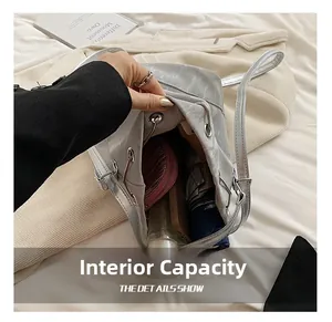 Interior view of silver bucket bag showing large capacity for phone, wallet and umbrella