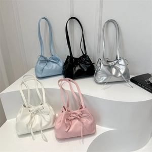 Minimalist drawstring hobo bag with bow detail in five pastel colors on display