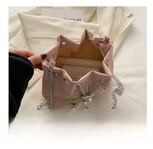 Detailed interior capacity of pink drawstring bucket bag with gold butterfly embroidery