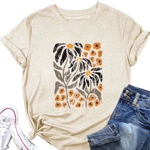 Detail of elegant yellow floral print on a beige crew neck t-shirt with a side knot hem
