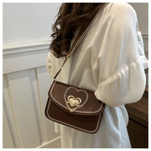 Brown leather crossbody bag with heart-shaped metal lock and white contrast stitching detail
