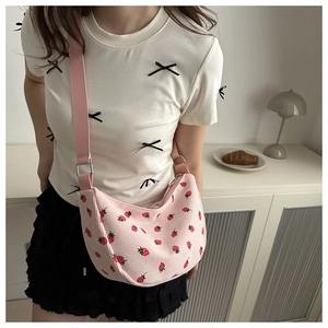 Detail of pink corduroy strawberry crossbody bag with adjustable wide shoulder strap