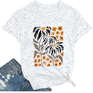 Close-up of white t-shirt featuring orange daisy print and stylish side knot detail