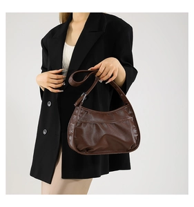 Brown soft PU leather hobo underarm bag shown styled on a model in a black blazer