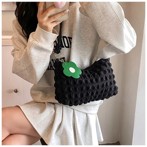 Black puffy cloud shoulder bag with green flower pendant and pleated nylon texture